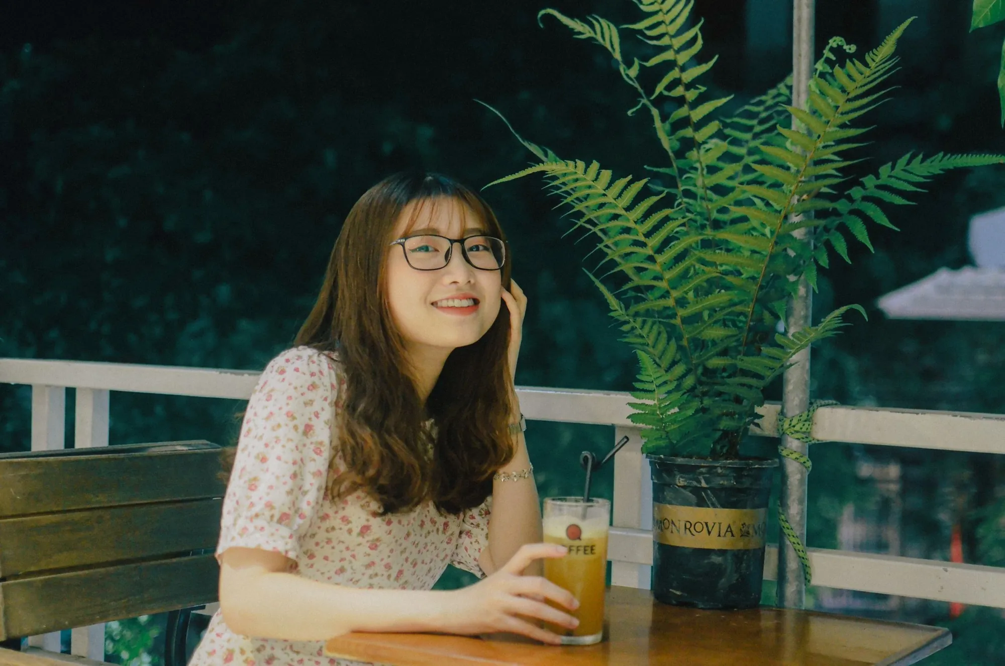 Young woman with glasses smiling in a café